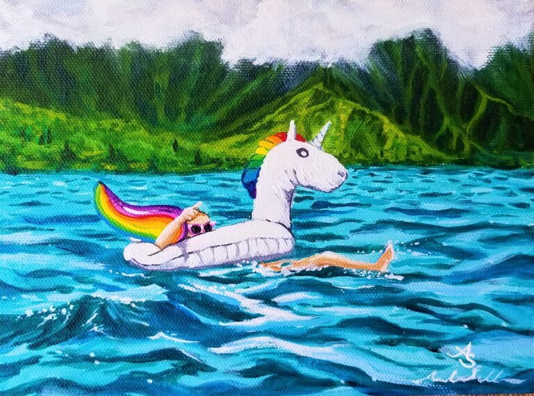 a happy swimmer sits in a unicorn floatie on the ocean with tropical mountains in the background