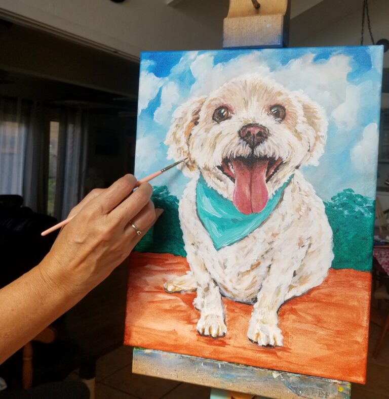 a photo of the artist painting a custom pet portrait of Max in the garden.